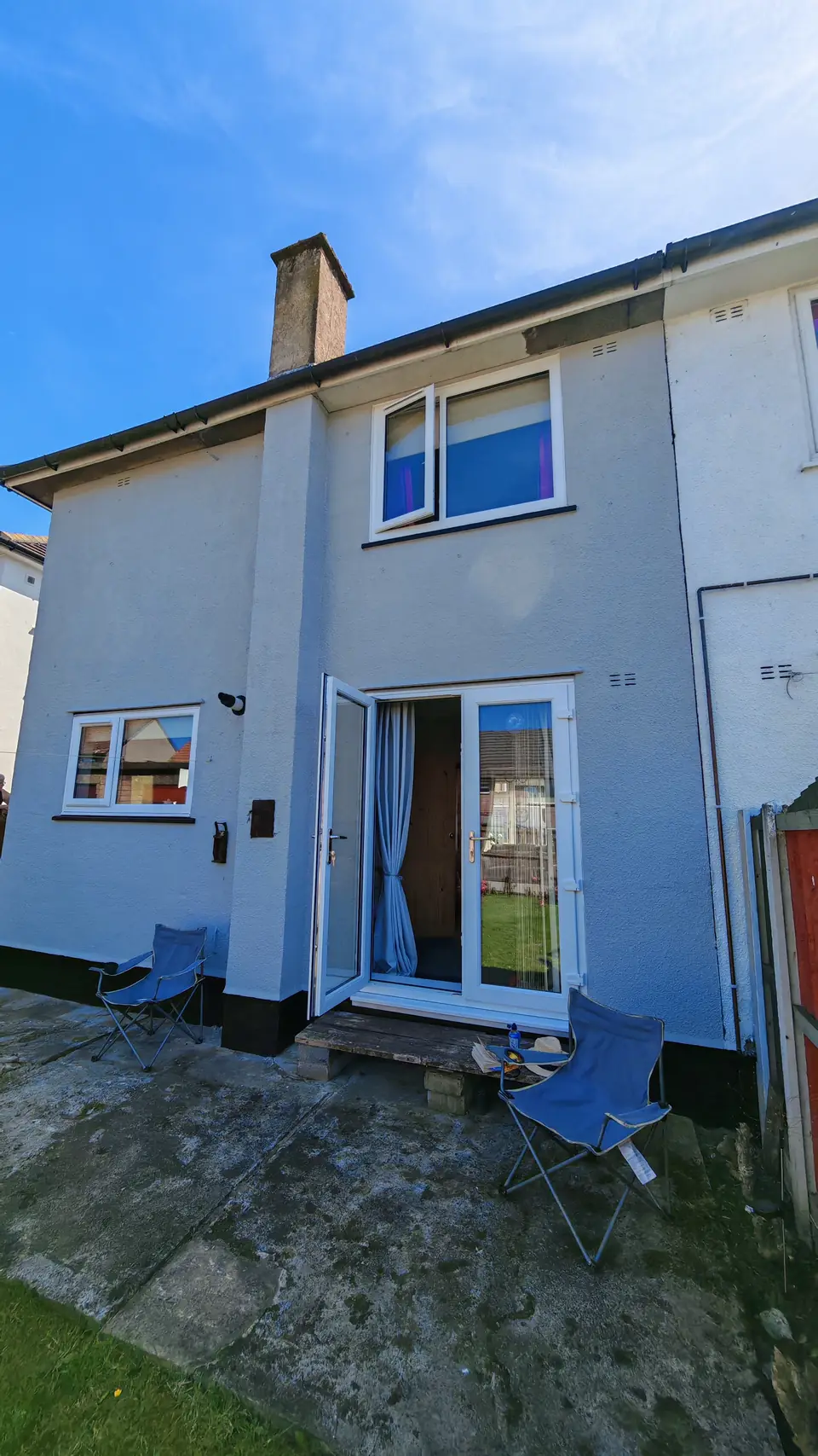 After: rear elevation in light grey masonry paint, black plinth