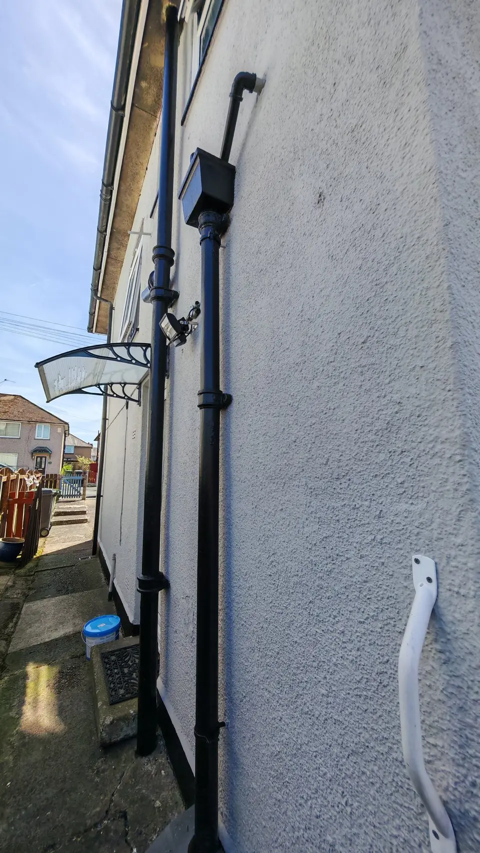 After: side wall in light grey with black downpipes
