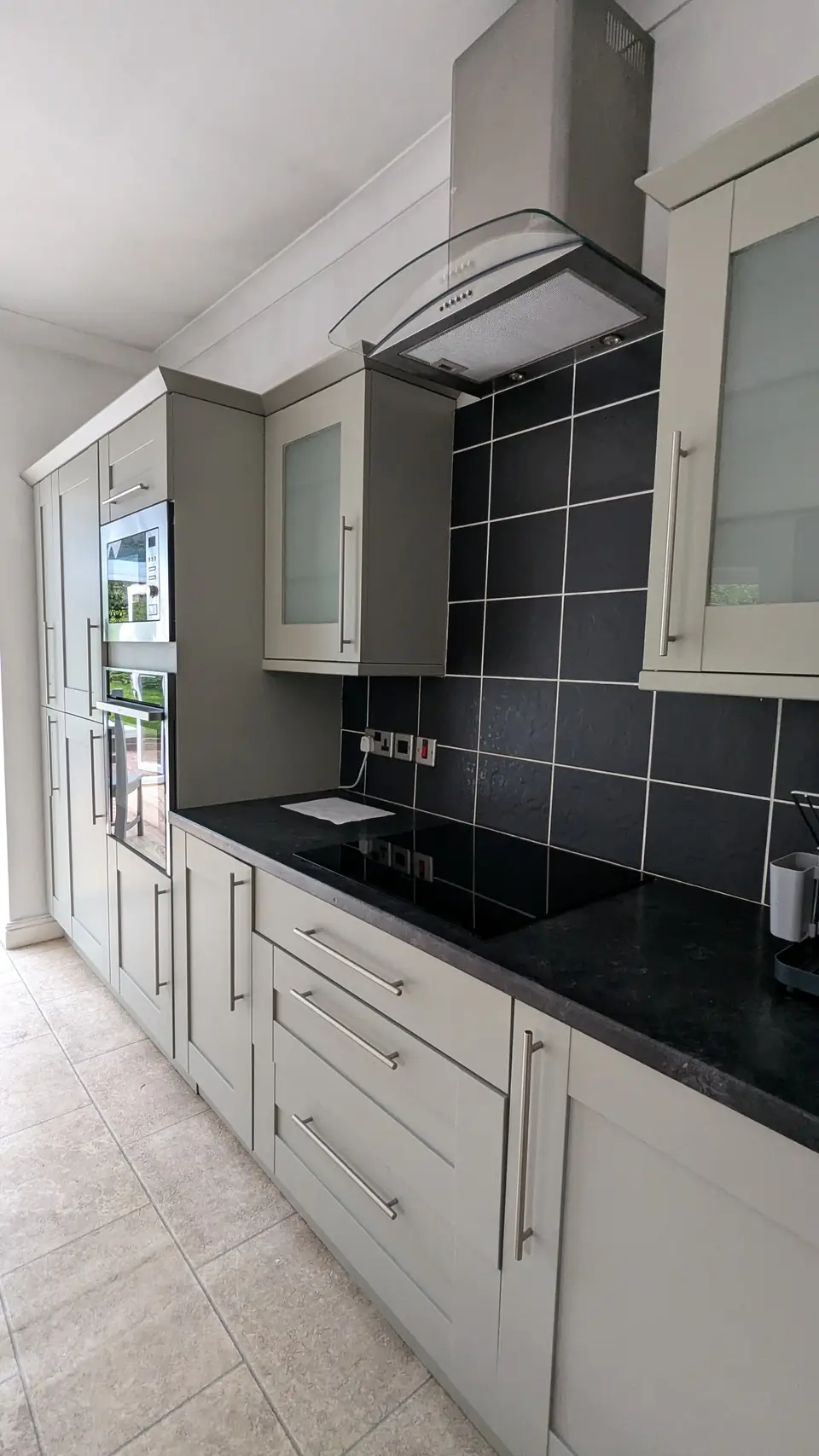 After: hob run sprayed light grey under black tiles