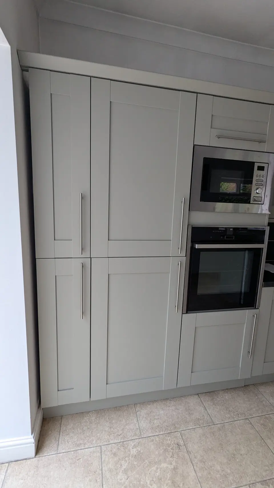 After: tall larder and oven units sprayed light grey