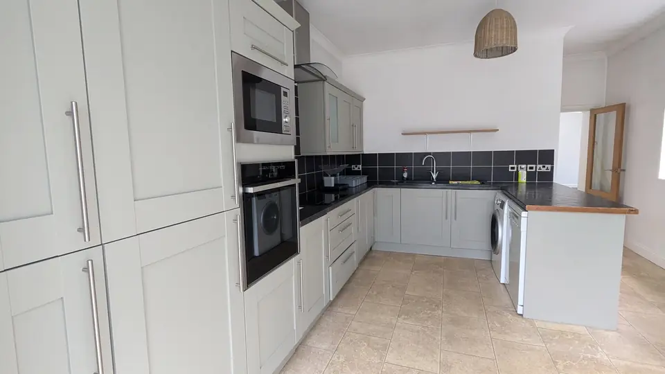 After: whole kitchen in light grey, ovens and island