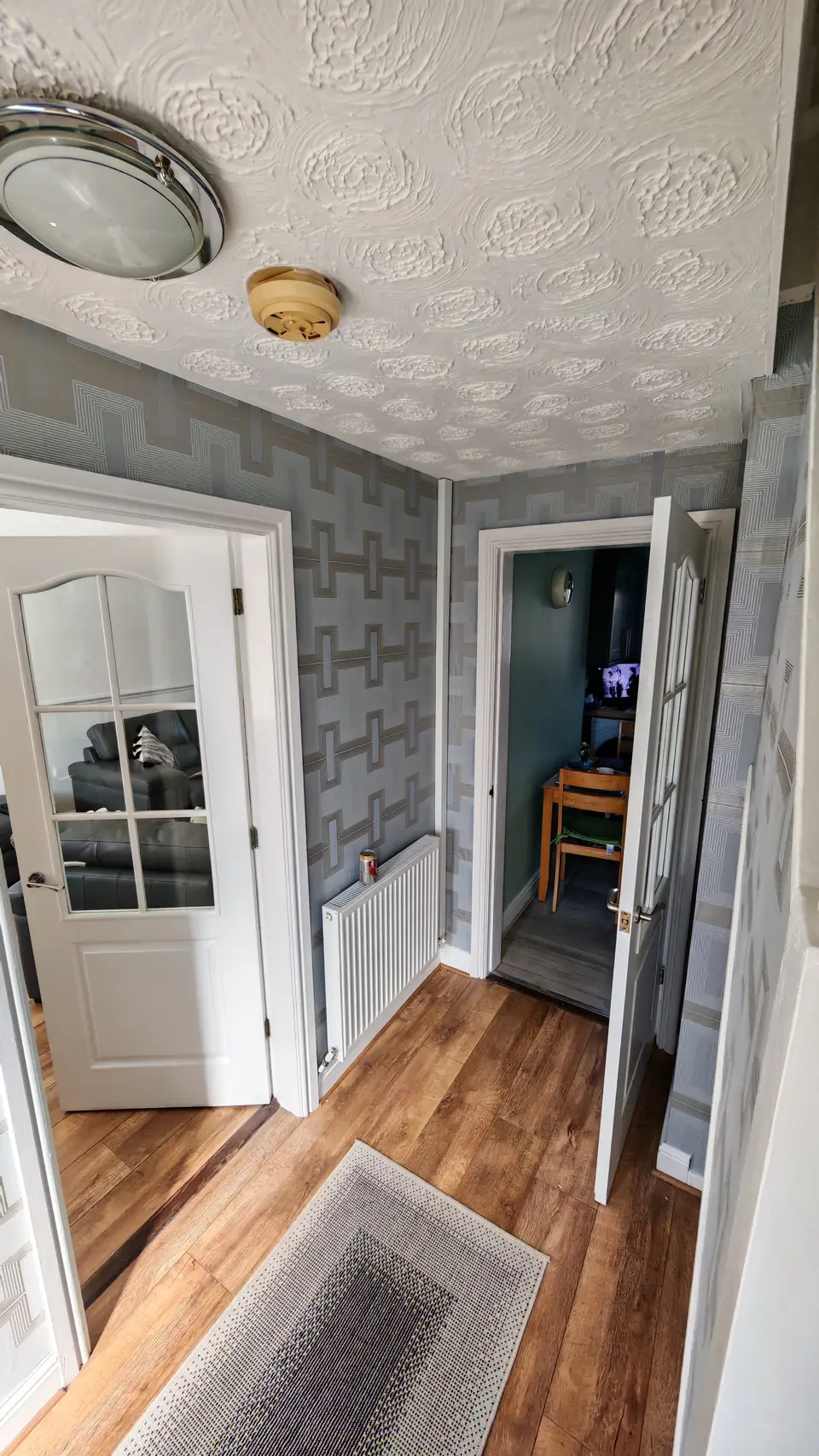 Geometric grey wallpaper around the hallway doors