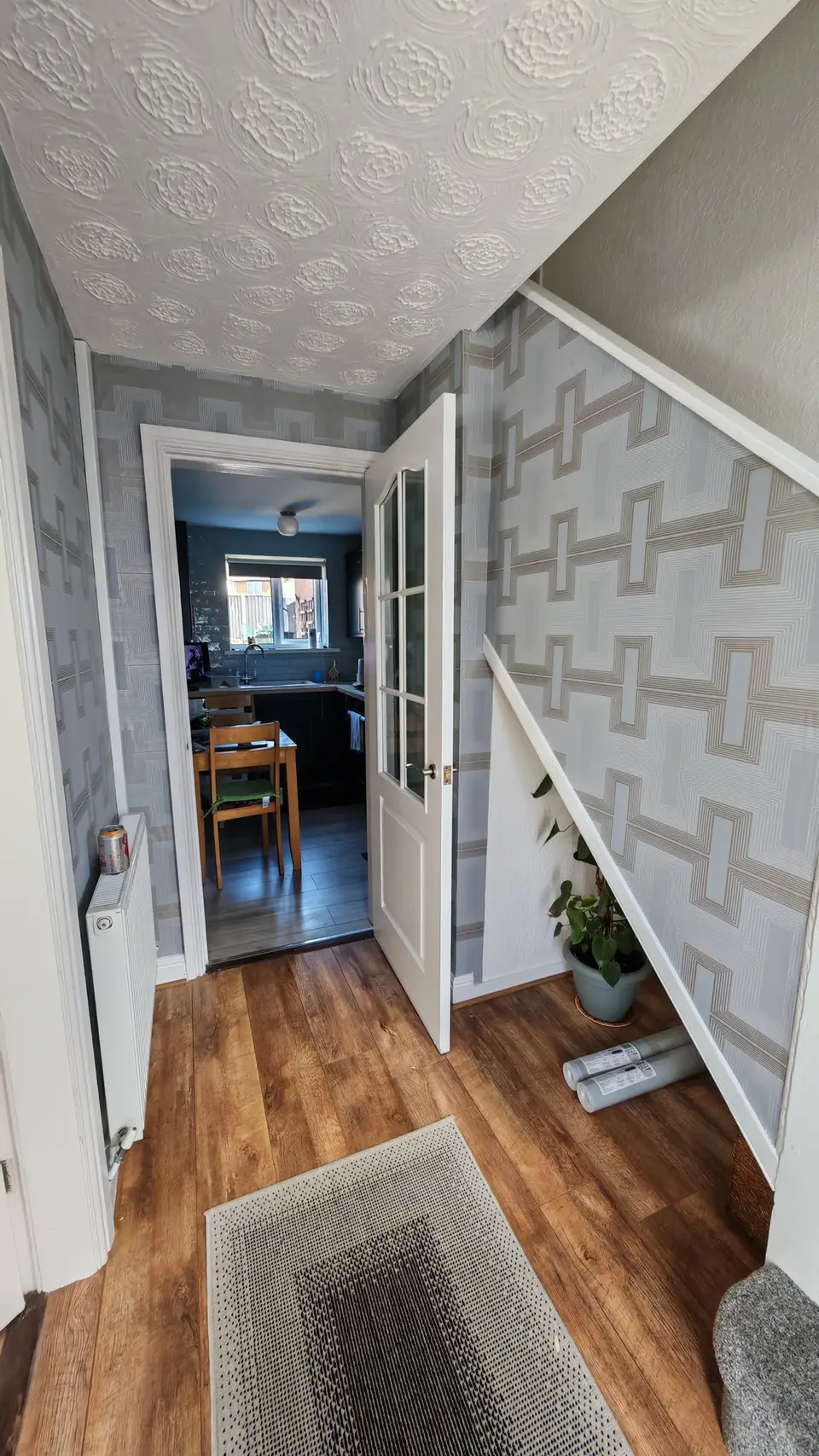 Geometric wallpaper up the stairs and through to the kitchen