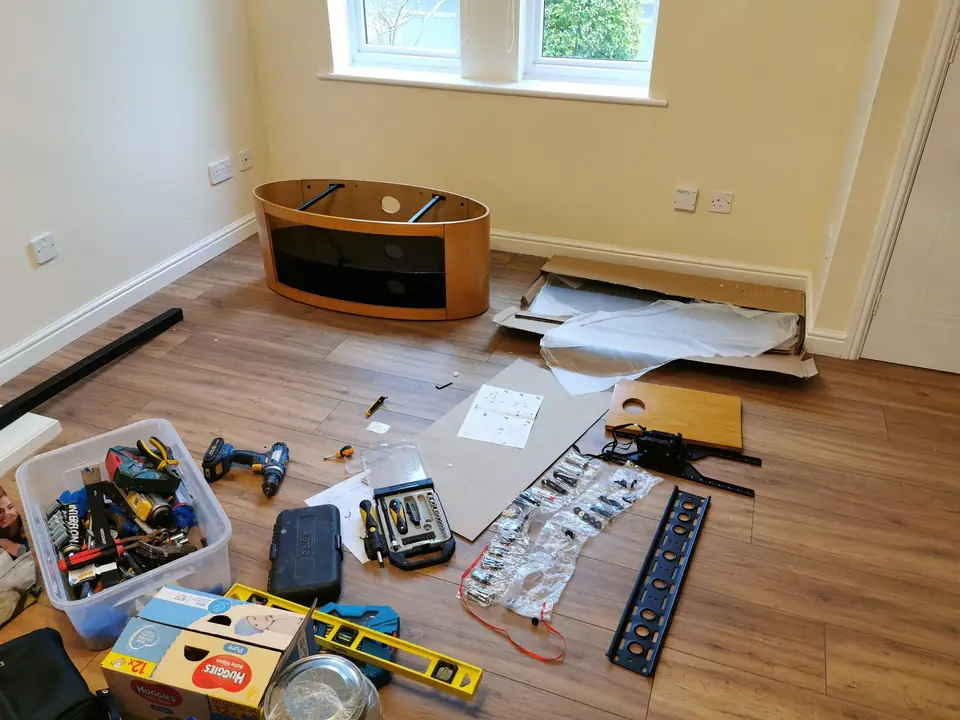 Handyman tools laid out for a fitting job: drill, saw, spirit level and toolbox