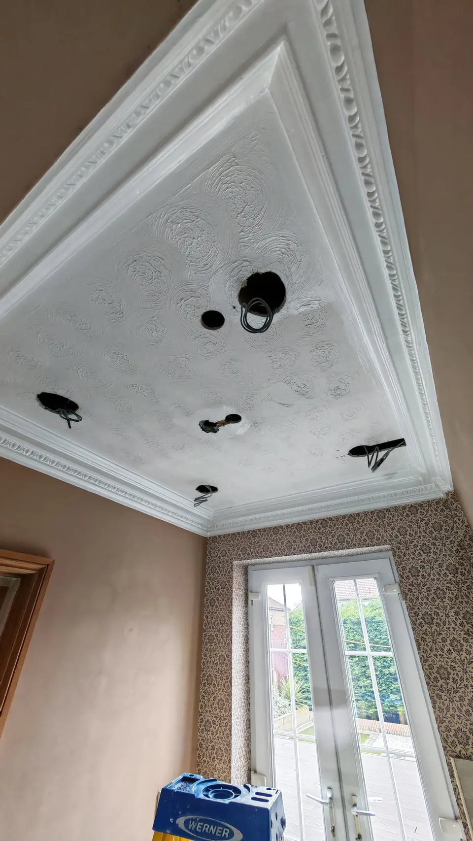 Before: the old Artex textured ceiling and patterned wallpaper