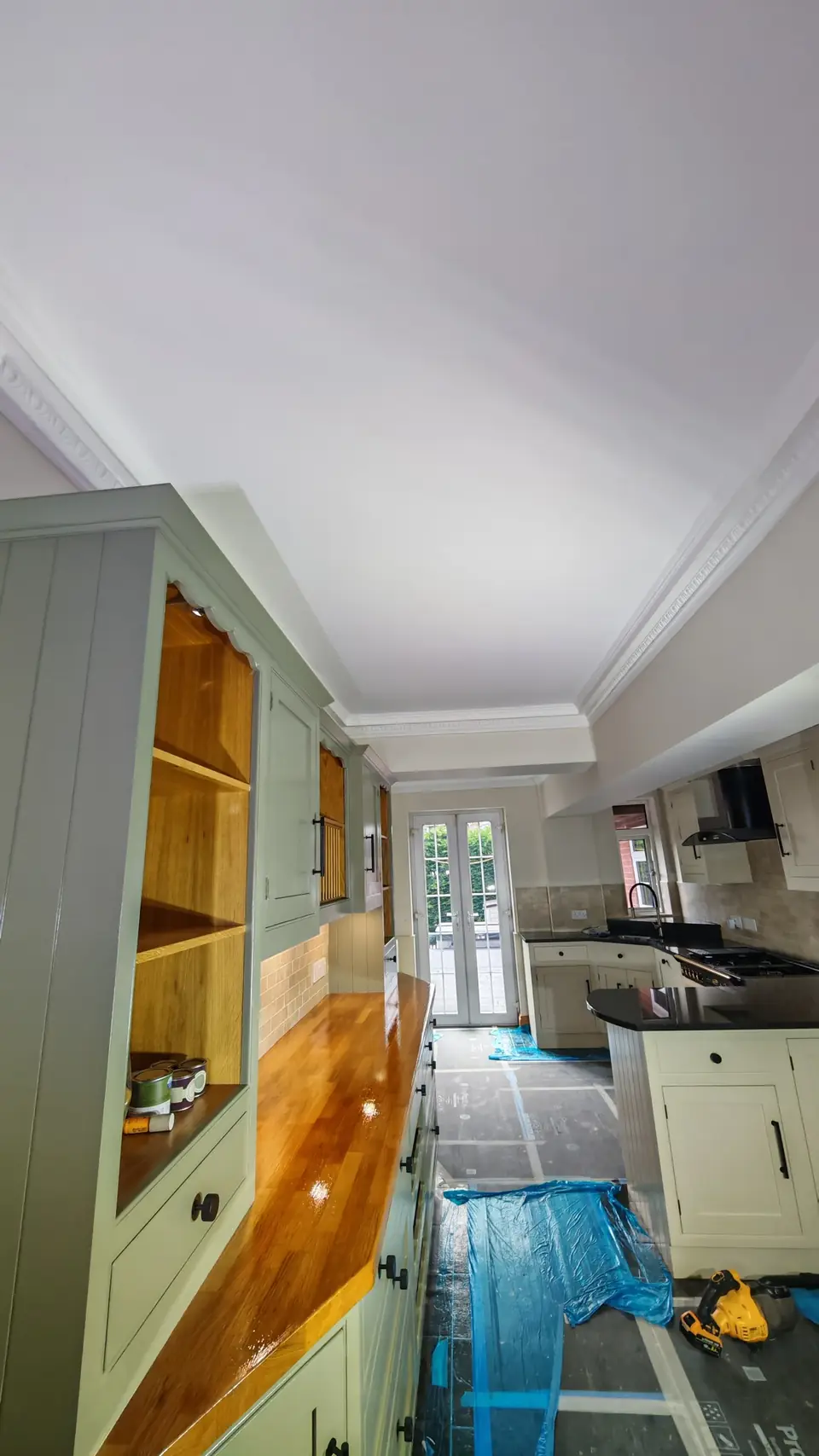 Finished: freshly painted white ceiling, sage dresser and French doors