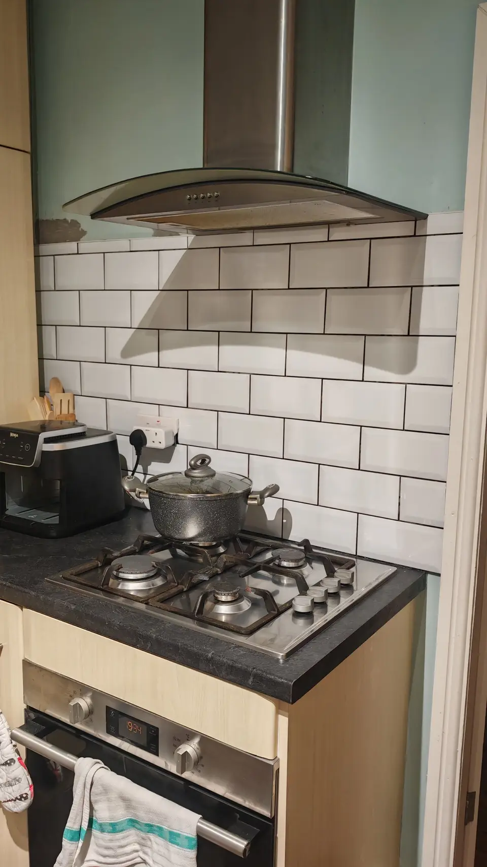 White metro tile kitchen splashback with black grout, finished