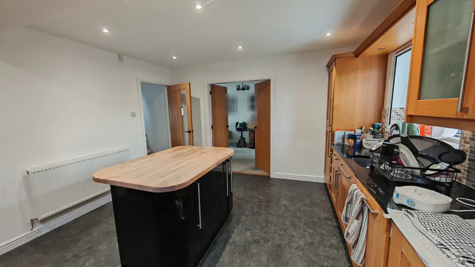 Kitchen-diner with fresh white walls and ceiling around the island