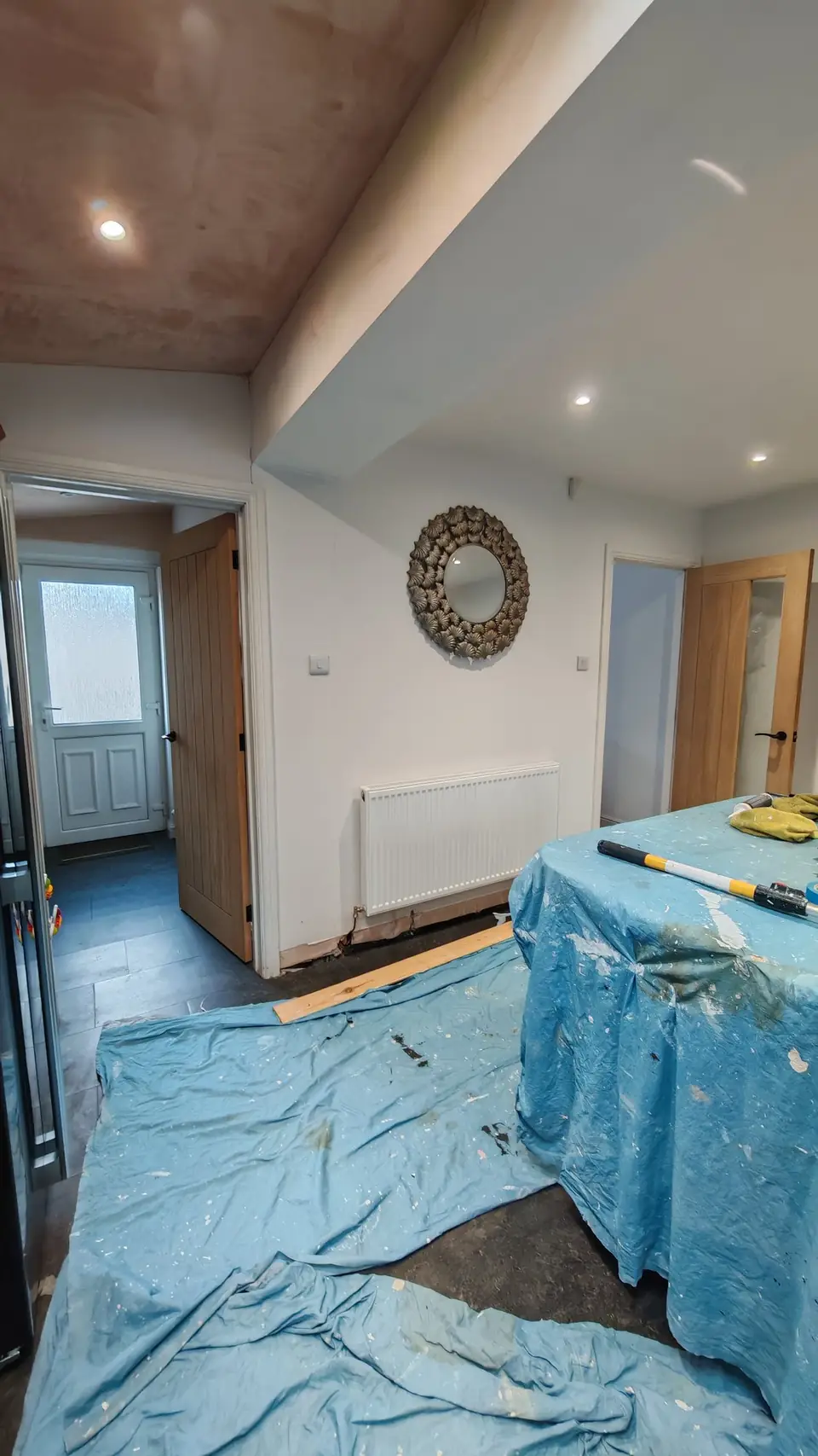 During: new plaster ceiling, everything below covered and protected