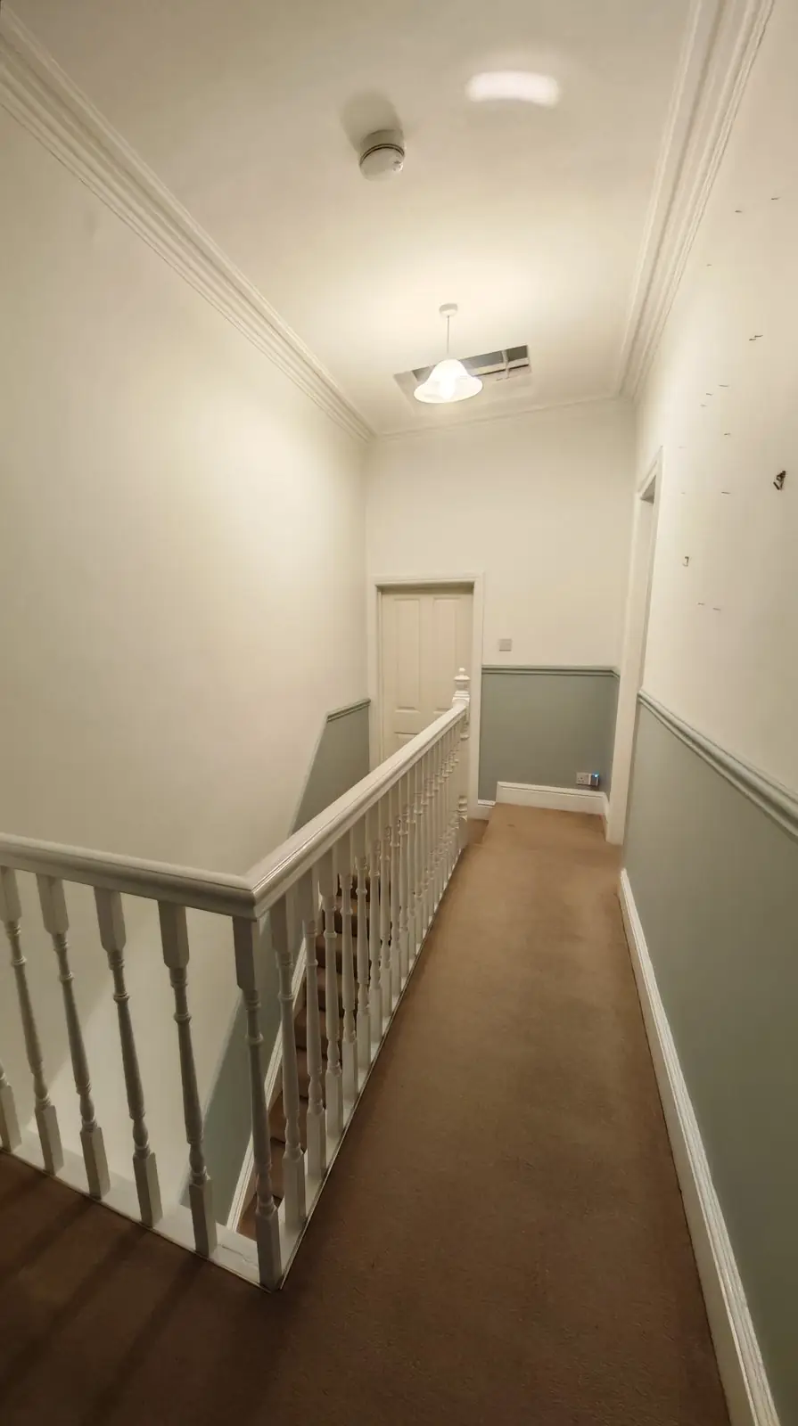 After: the same corridor in grey-green and off-white