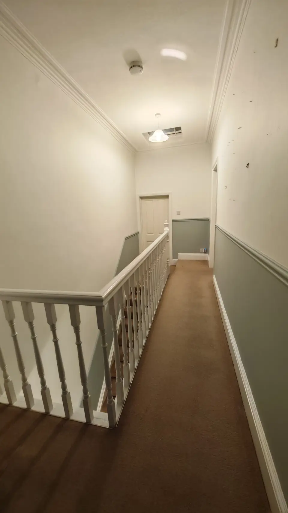 Landing corridor looking back towards the stairs, white gloss spindles