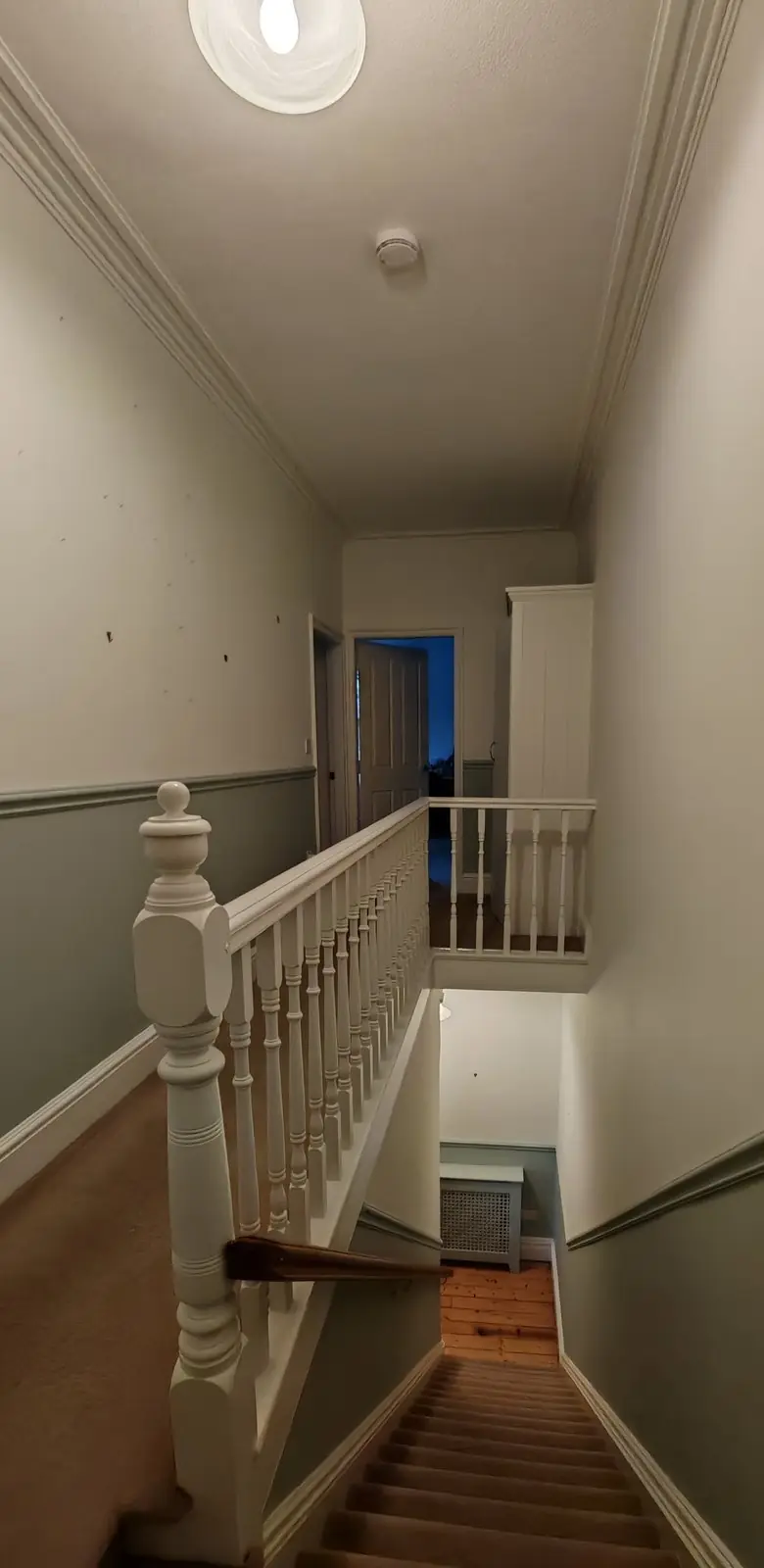 After: the same landing in grey-green and off-white with white gloss woodwork