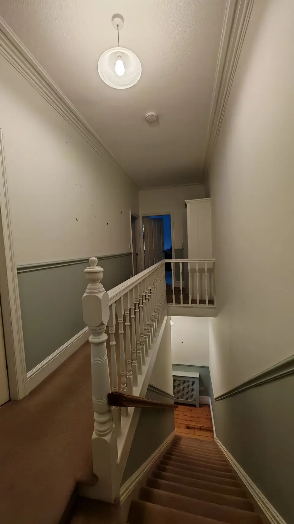 Stairs and landing repainted: grey-green below the dado rail, off-white above, white gloss spindles and woodwork
