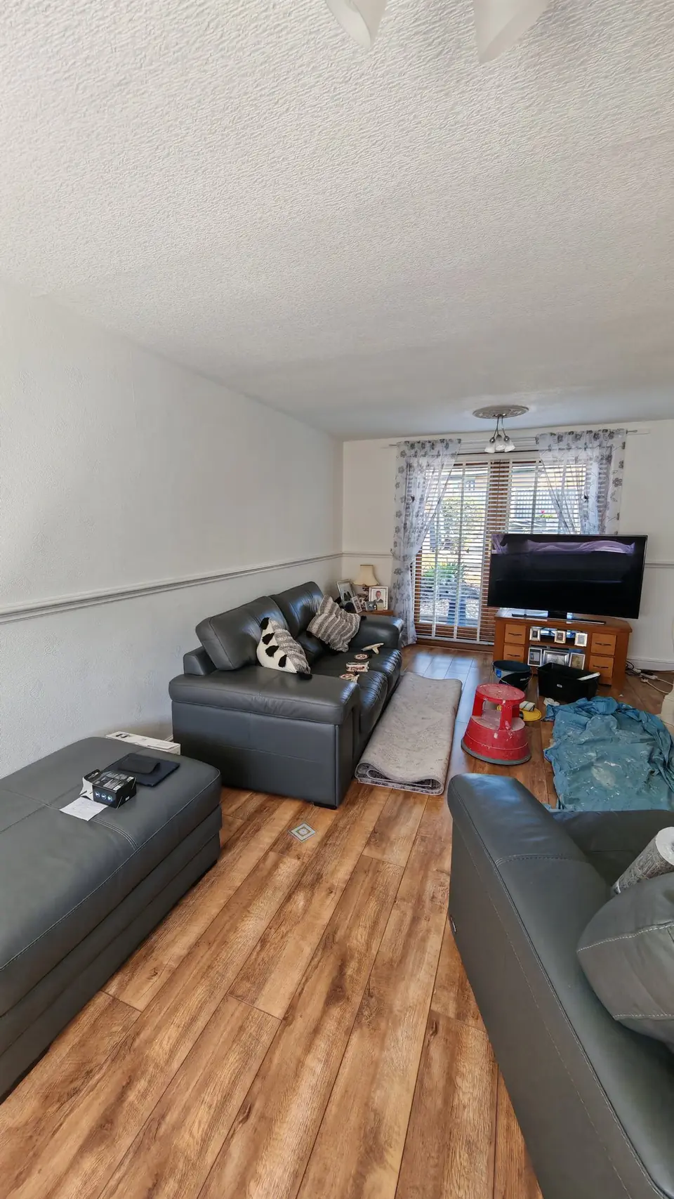 Before: living room with plain walls and dado rail