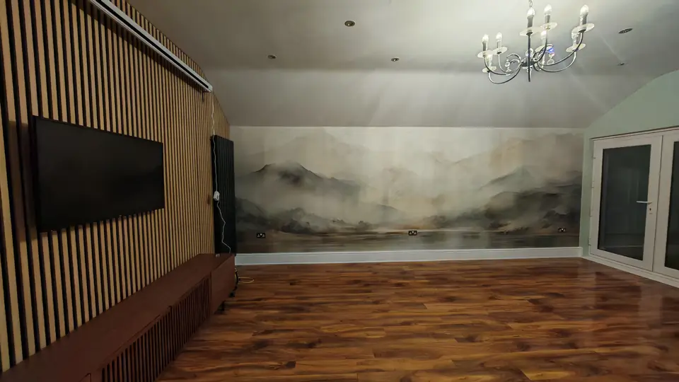 Misty mountain landscape mural running the length of the loft wall