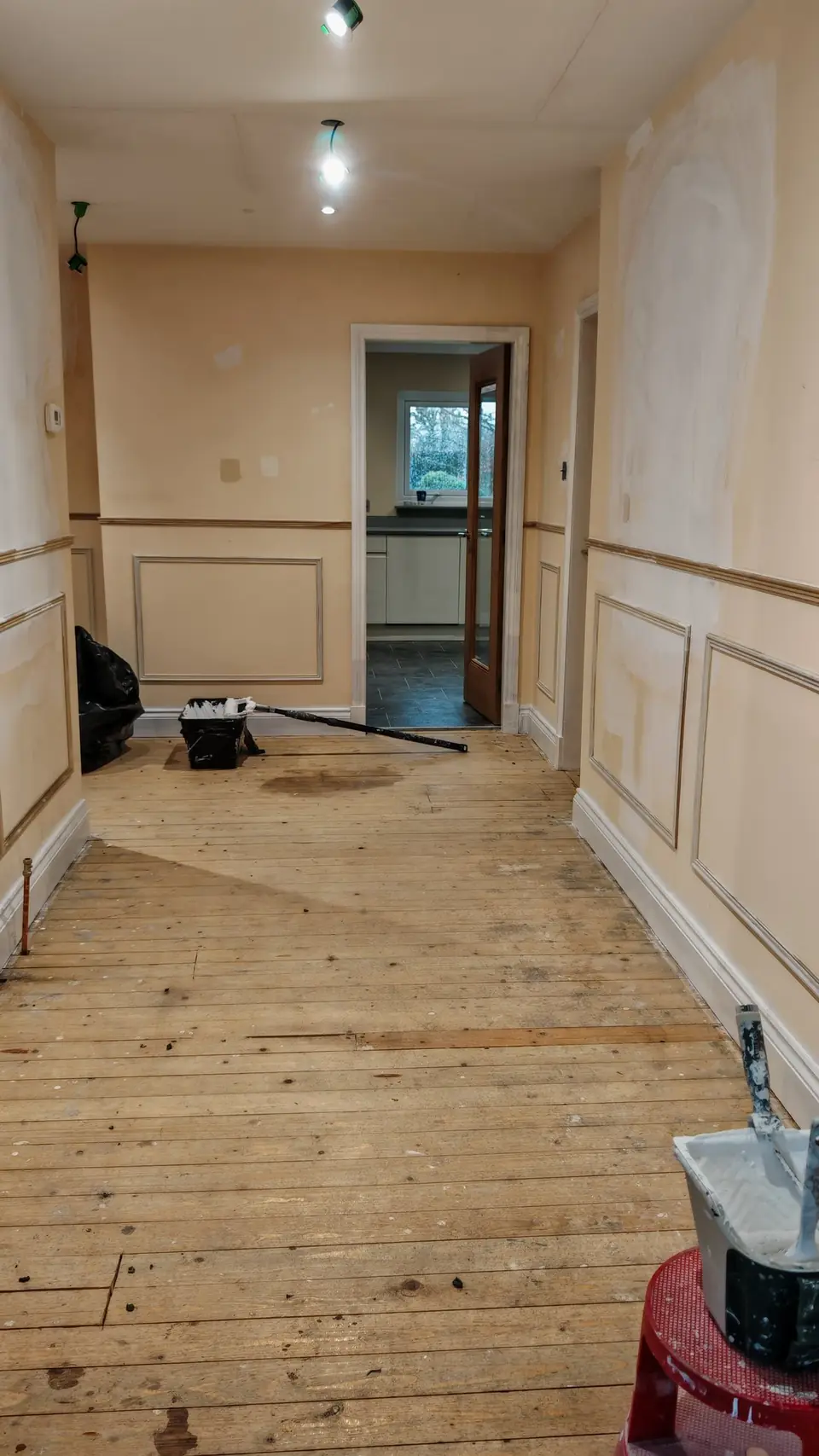 During: MDF panel frames and dado rail fitted along the long hallway