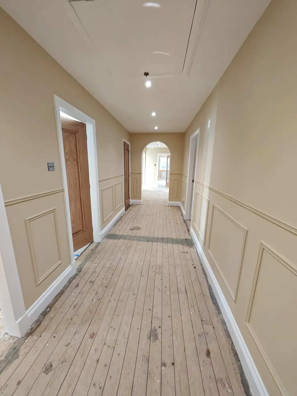 Painted hallway panelling running through to the arch