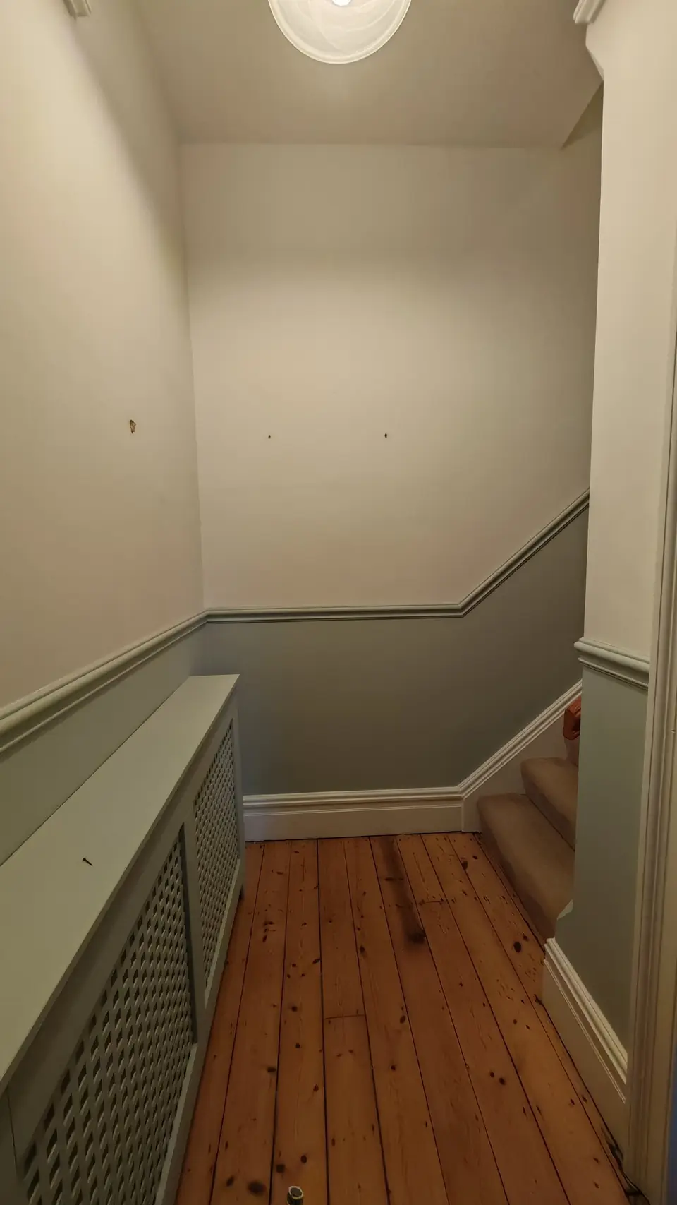 Lower hall with the radiator cover painted grey-green to match
