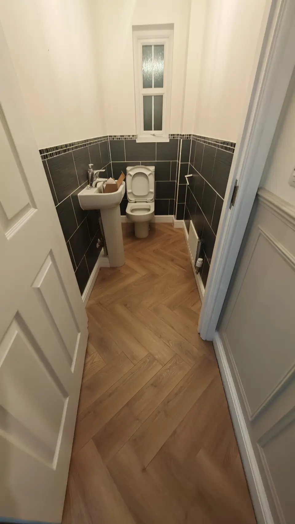 Herringbone LVT floor in a cloakroom WC