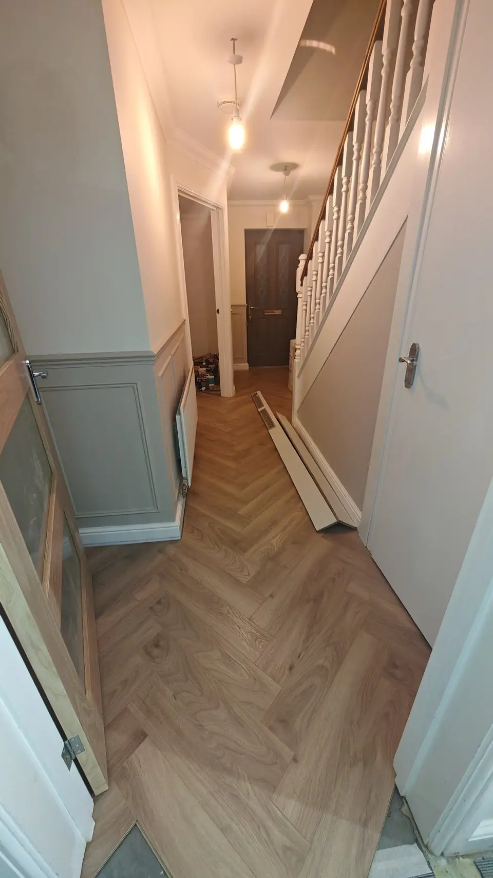 Herringbone LVT flooring along a hallway with panelling