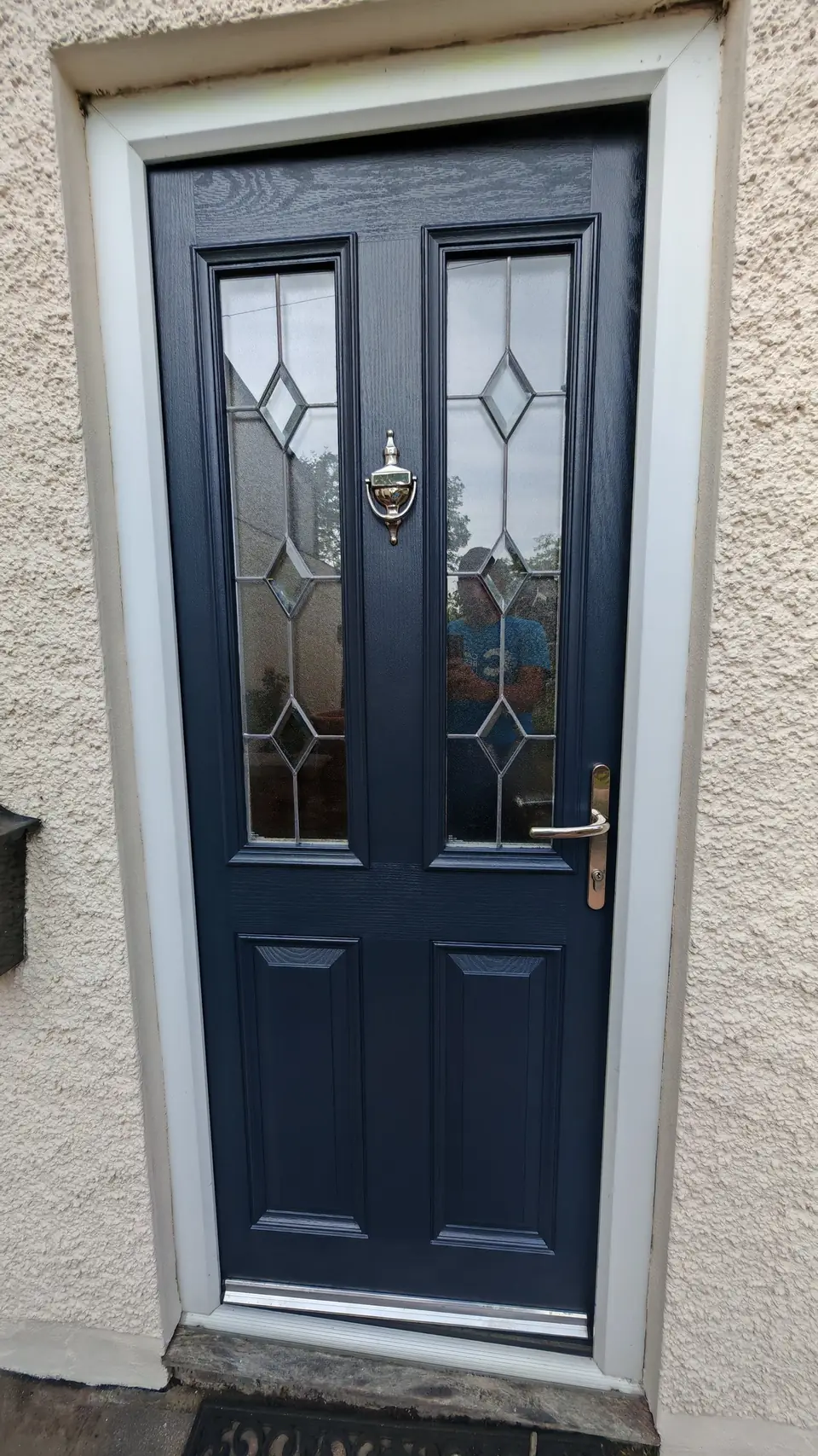 After: the same front door sprayed navy blue
