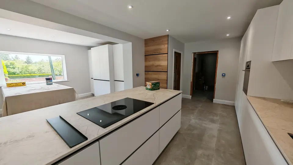 Kitchen extension finished: light grey walls and white ceiling over a white island