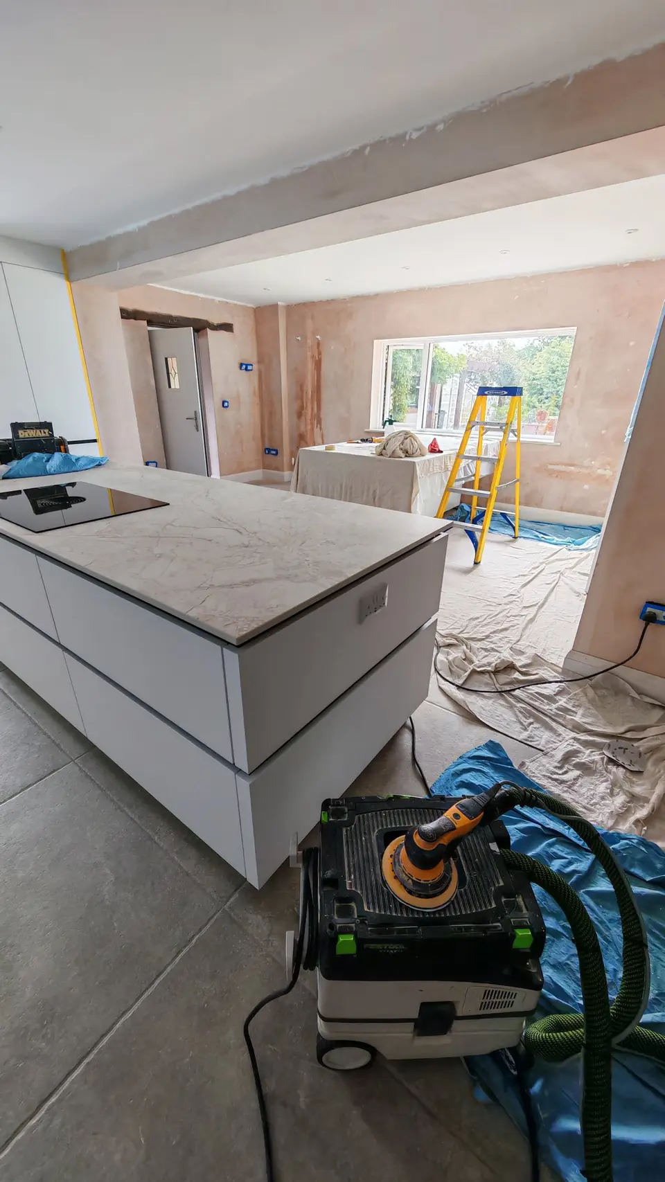 Before: bare new plaster, island masked, Festool dust-extracted sander ready
