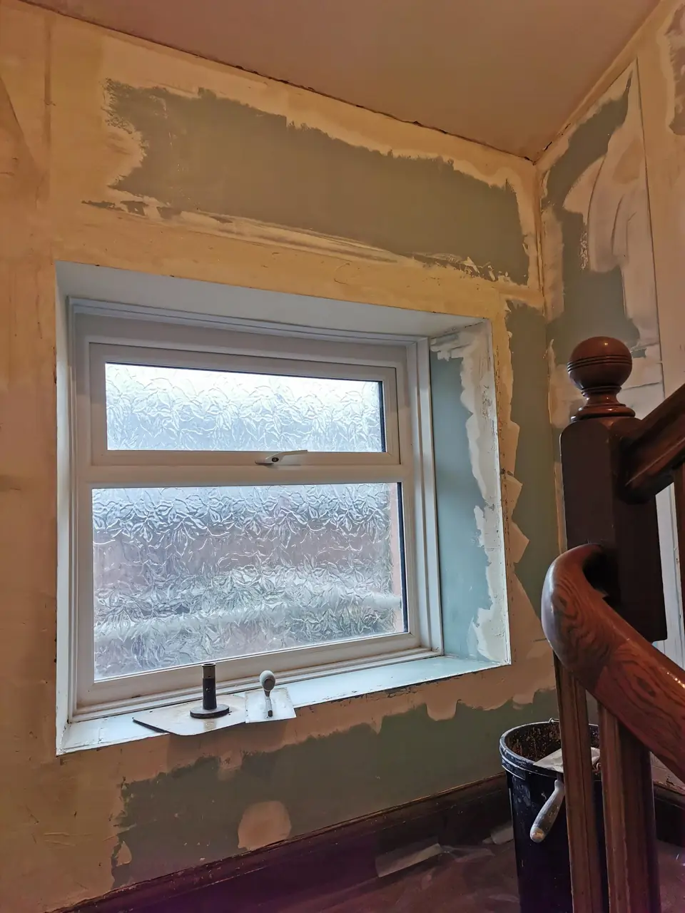 Patched and skimmed walls around a landing window, making good before decorating