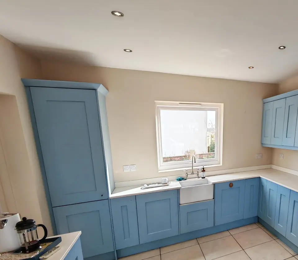 After: the same kitchen resprayed in soft blue