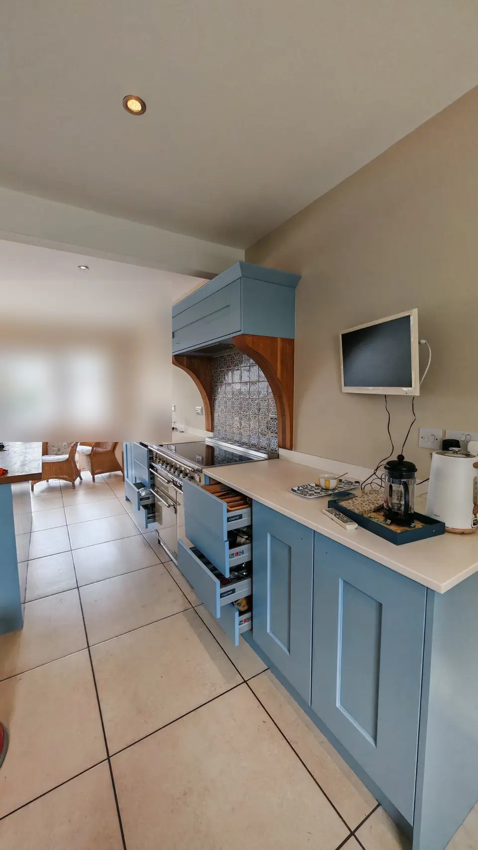 Range cooker run in soft blue, looking towards the French doors
