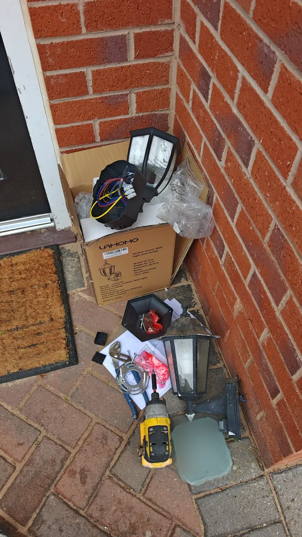 During: old lamp and number plaque taken down, new light ready to fit