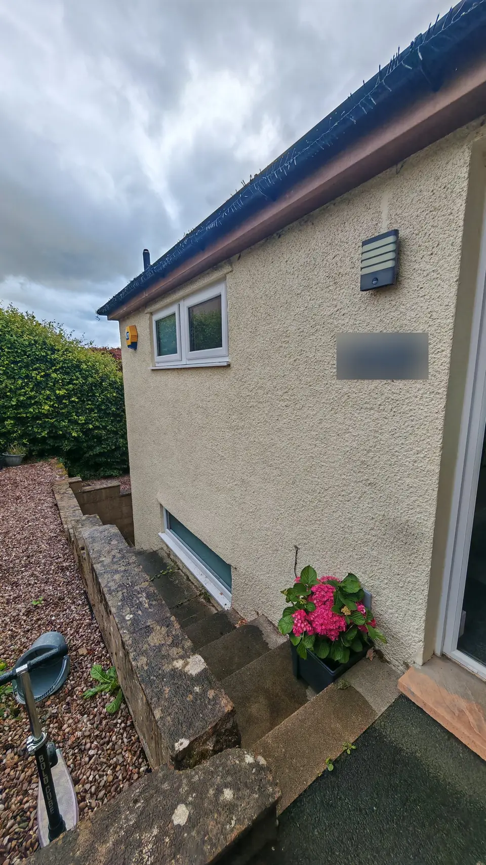 After: front wall by the steps painted in cream masonry paint