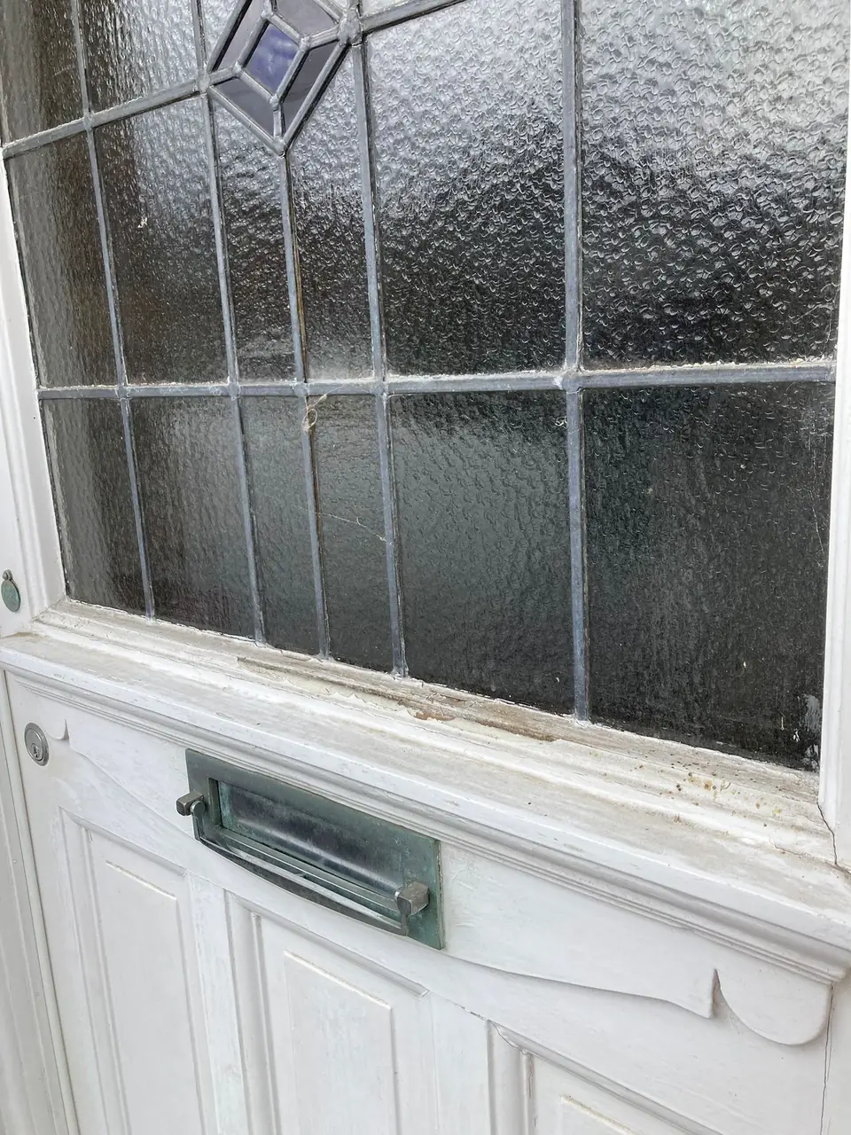 Before: worn paint around the leaded glazing and letterbox