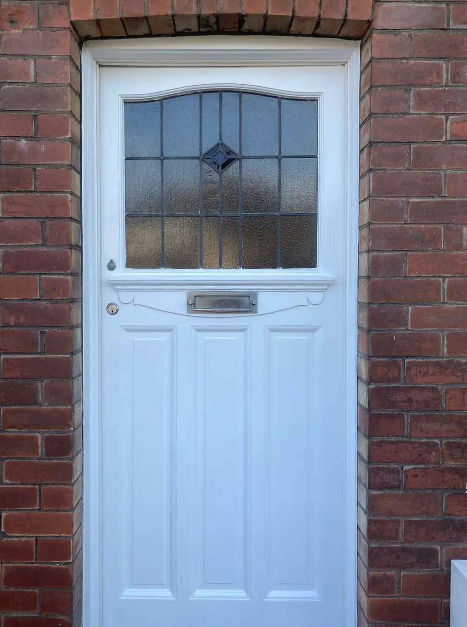 After: the same door repainted crisp white