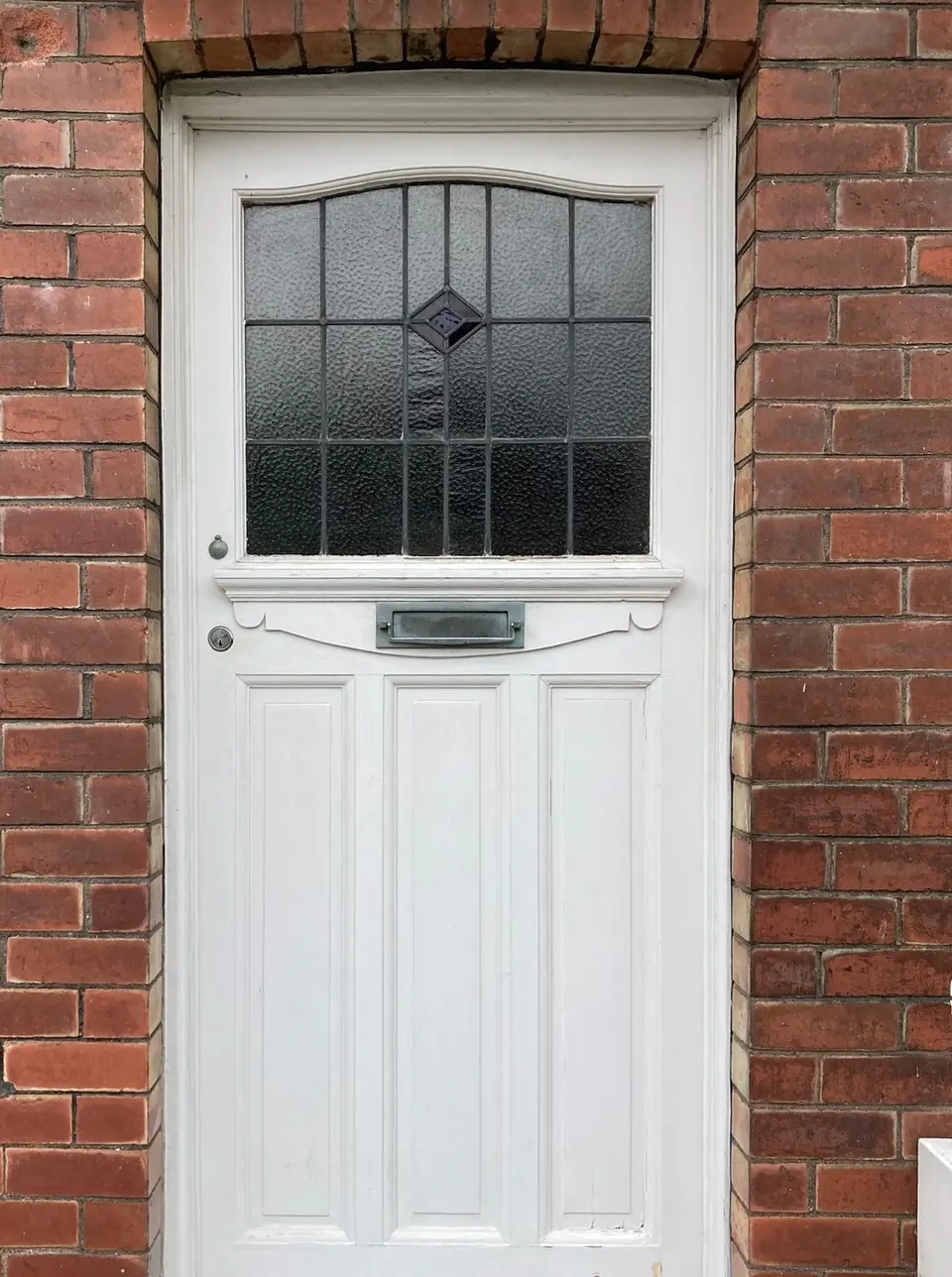 Before: period front door with cracked, flaking white paint