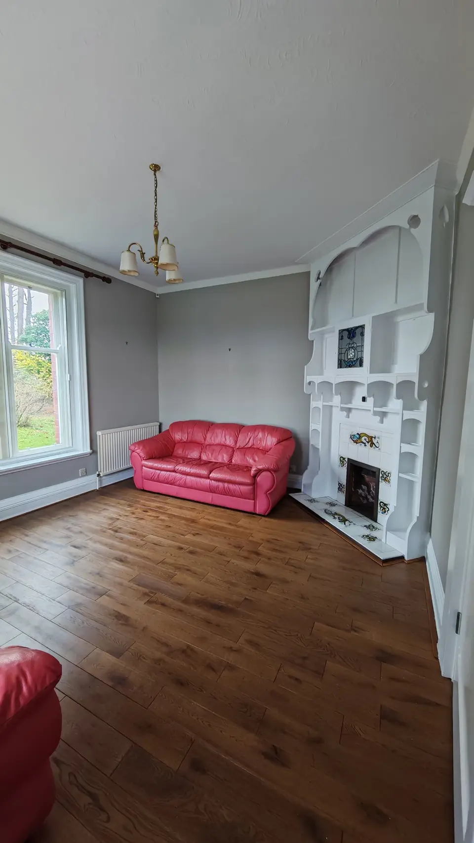 Ornate white fire surround against soft grey walls