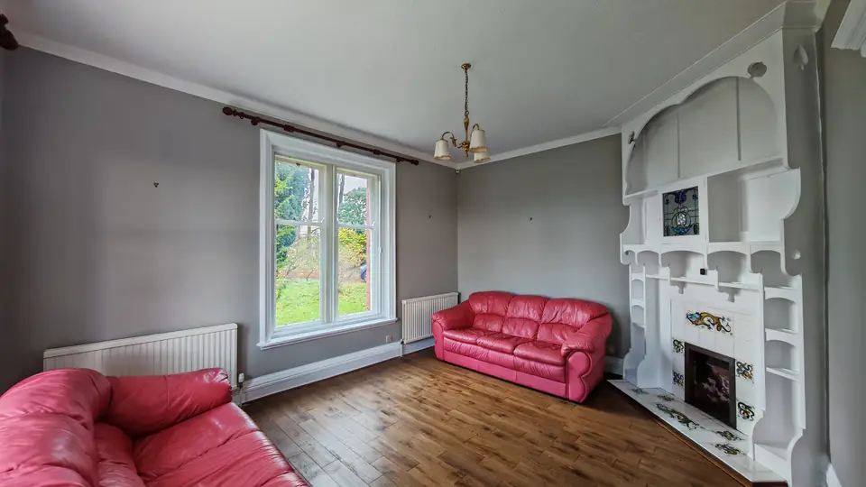 Period lounge repainted: soft grey walls, white sash window and ornate fire surround