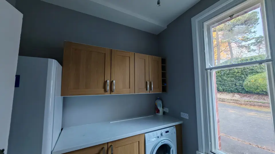 Utility room in soft grey with white woodwork