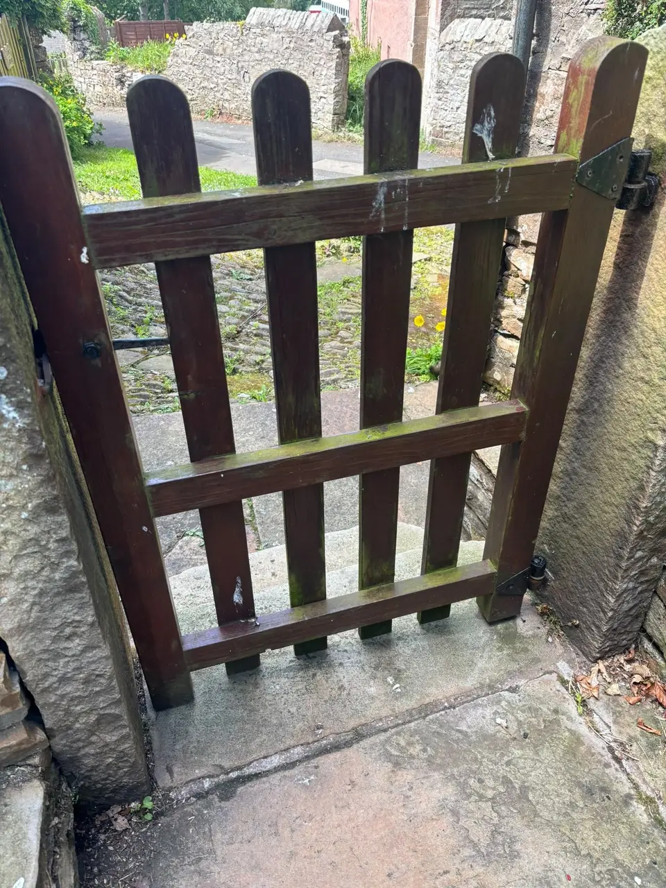 Before: mossy wooden gate at the side of the house