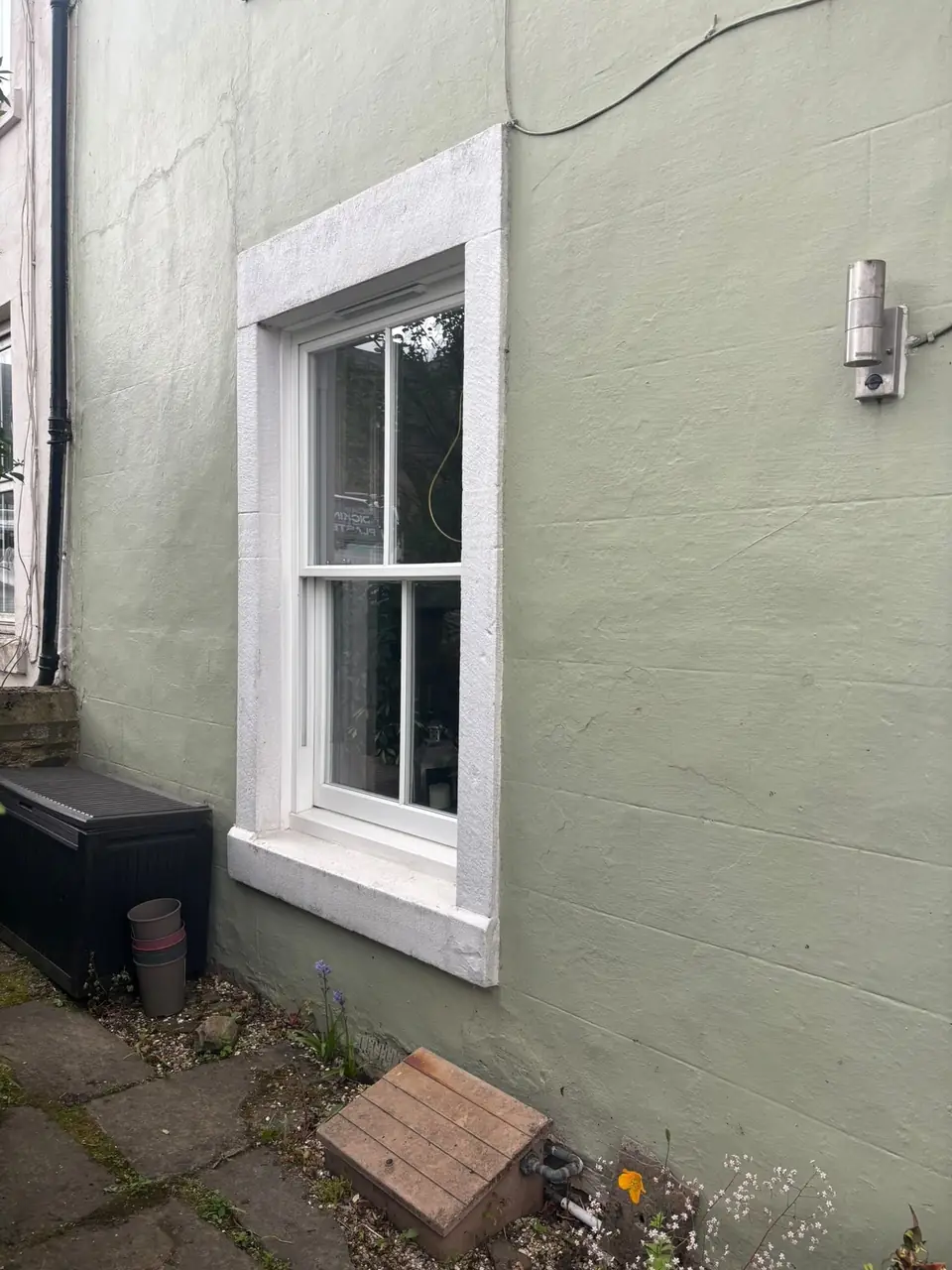 Before: peeling paint on the window surround and sill