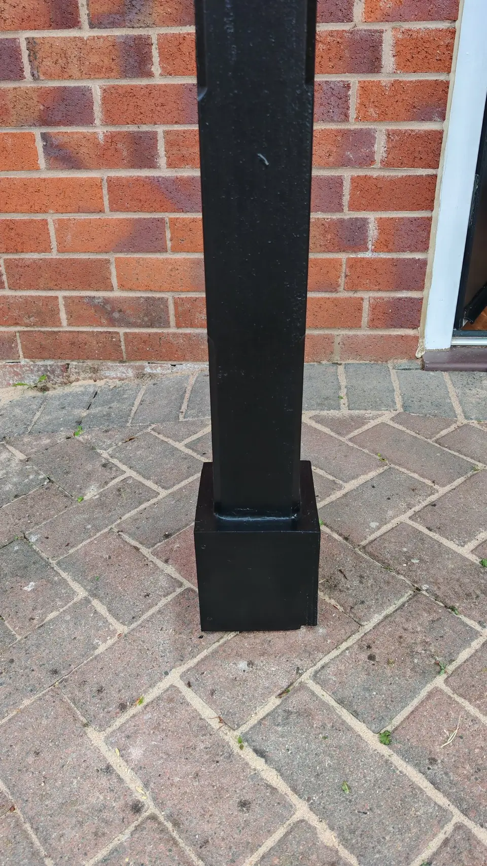 Porch post base painted black to match the door