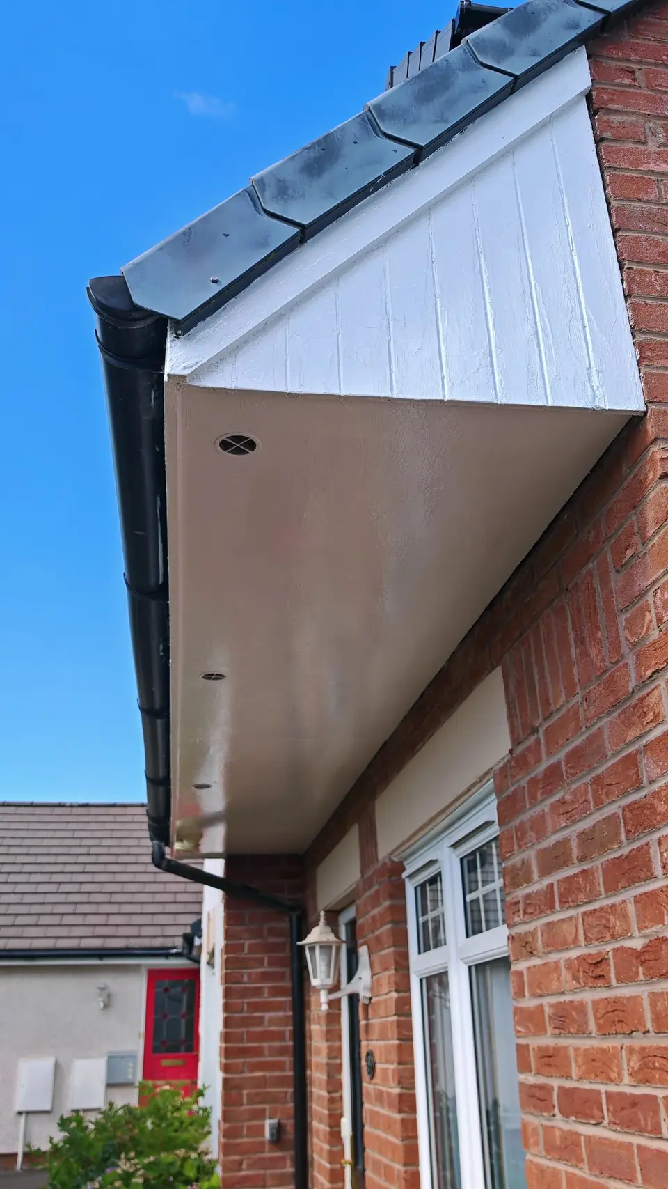 After: the same porch soffit and gable cleaned, prepped and glossed white