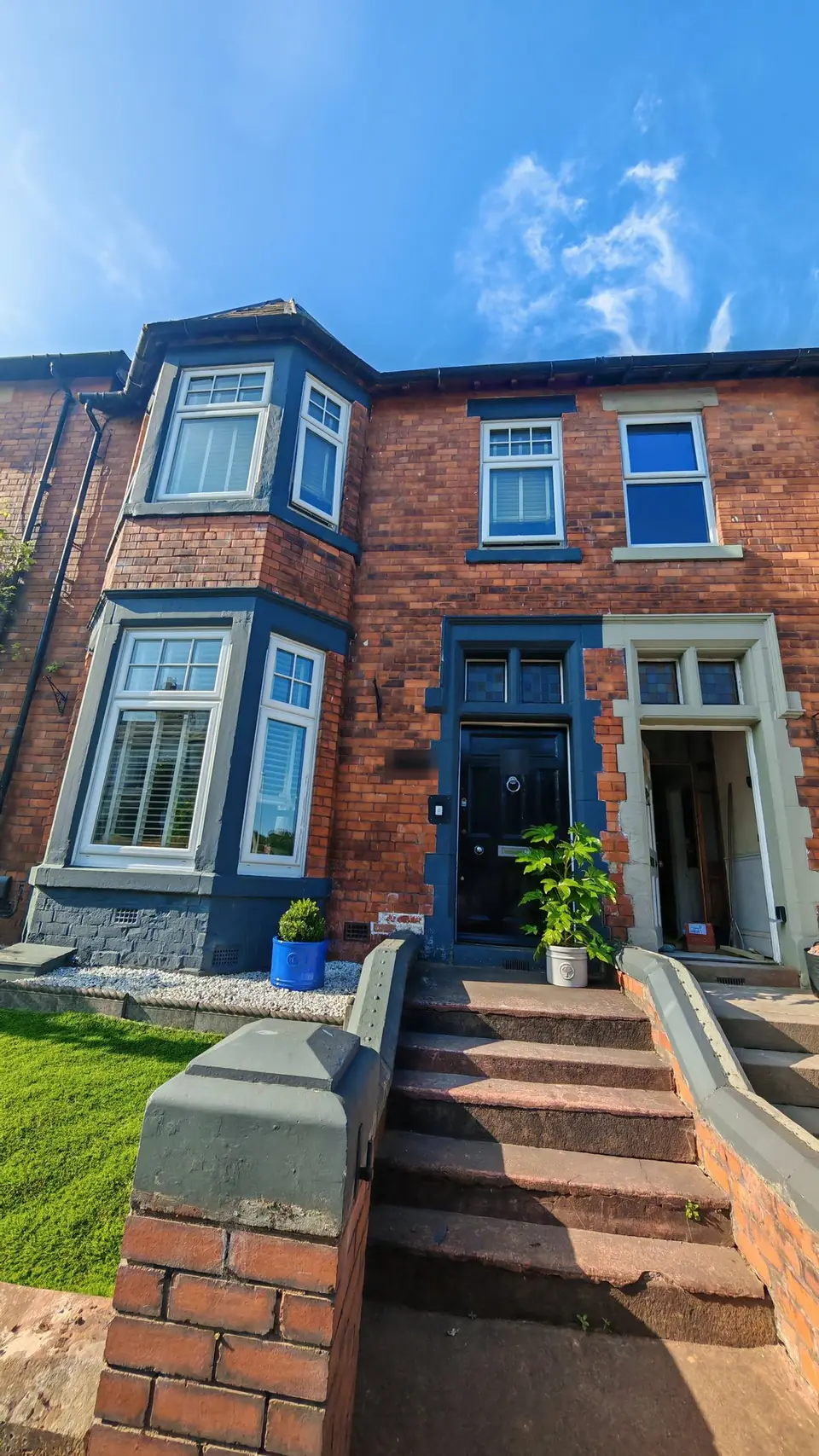 Front elevation with the bay, door surround and wall coping in dark grey-blue