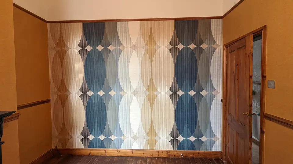 Retro wave-pattern wallpaper in blue and cream on a feature wall