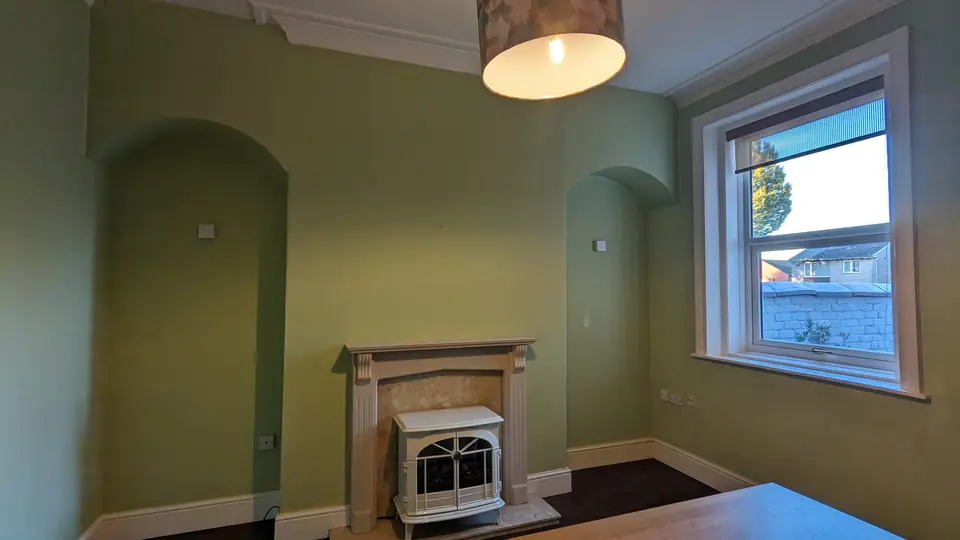 Sage green dining room, window and fireplace alcove