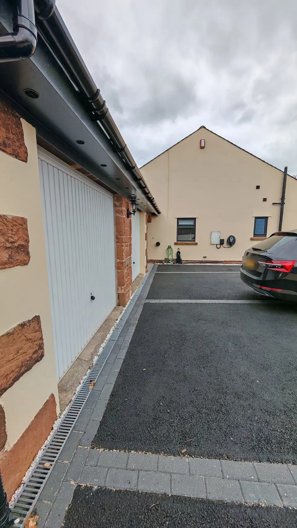 Garage side and driveway, walls in cream masonry paint