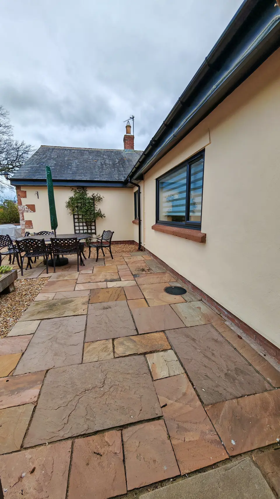 Rear wall in fresh cream masonry paint by the patio