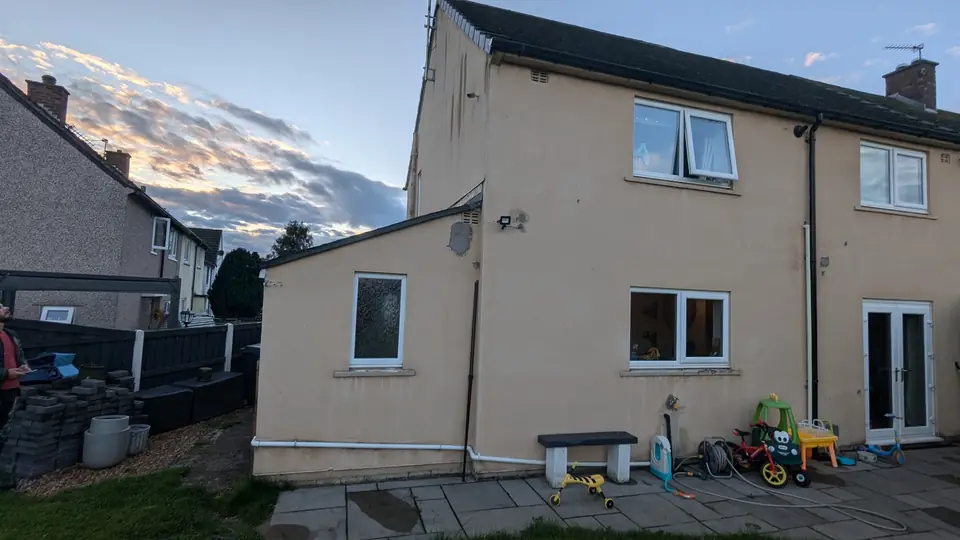 Before: beige semi-detached house from the garden