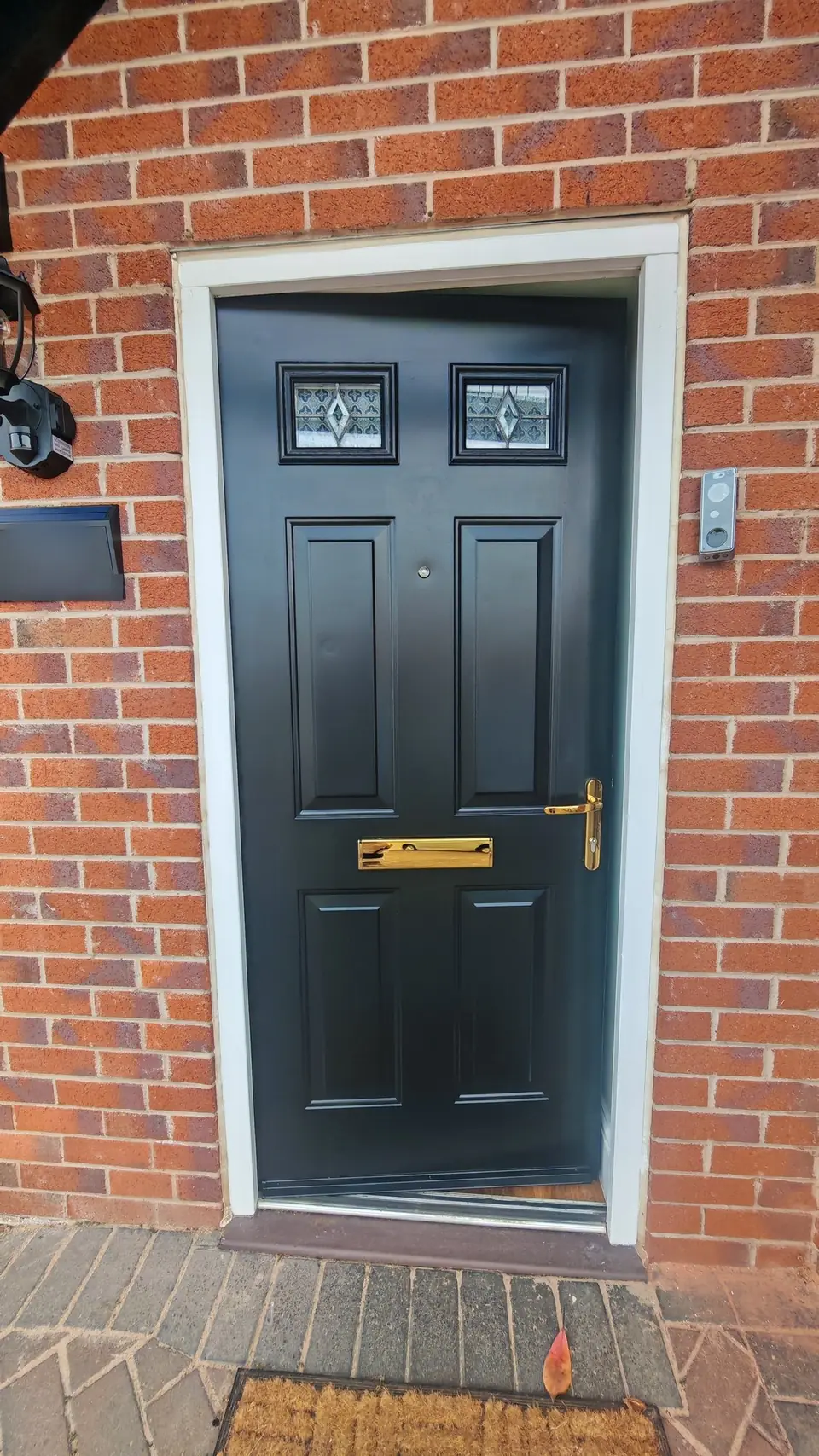 New slate house-number sign fitted beside the black gloss front door
