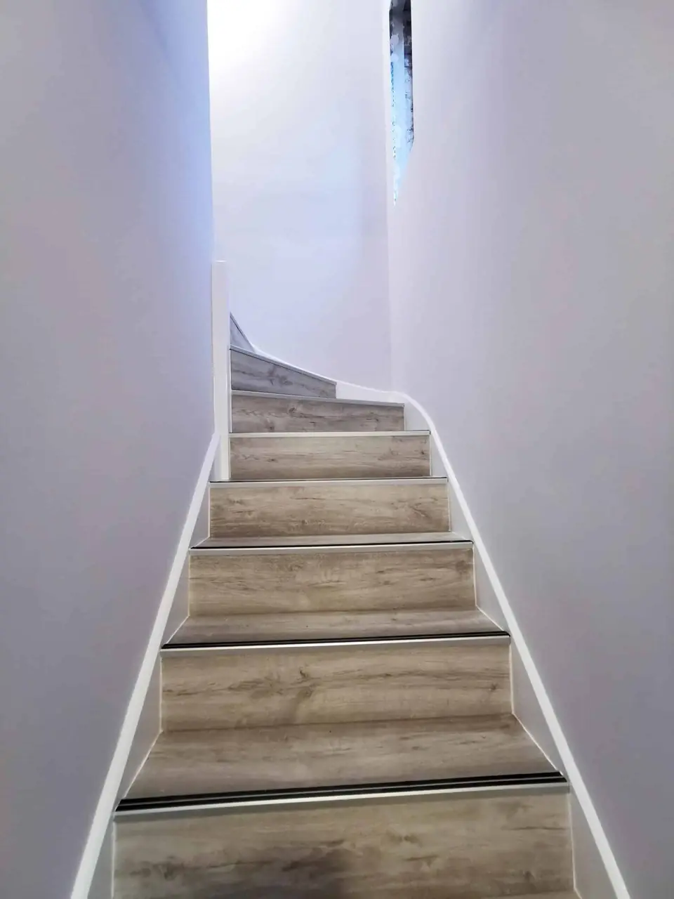 Narrow staircase painted bright white